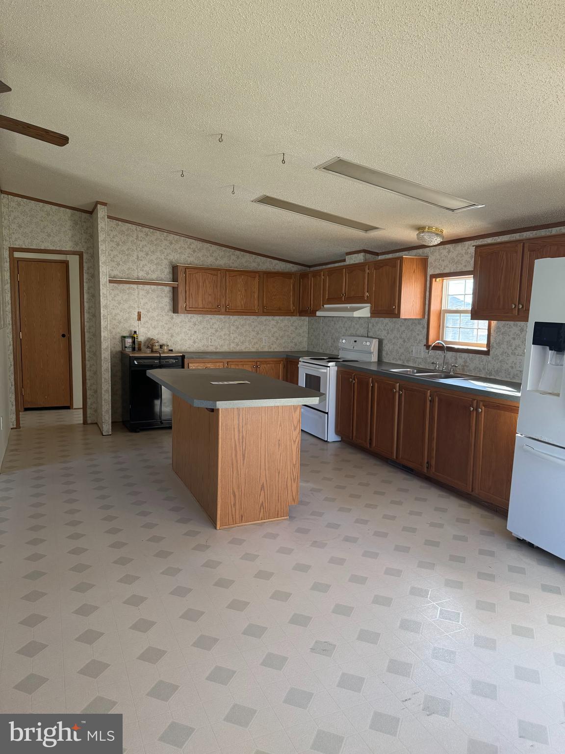 102 Front Street Centre Hall, PA 16828 - Photo 4 of 11 a kitchen with stainless steel appliances granite countertop a stove and a refrigerator