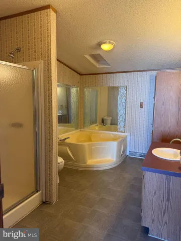 a view of a bathroom with tub and mirror