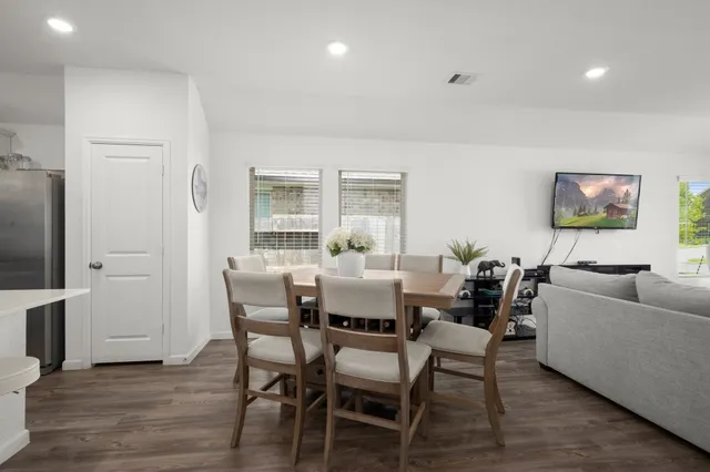 a dining room with furniture and wooden floor