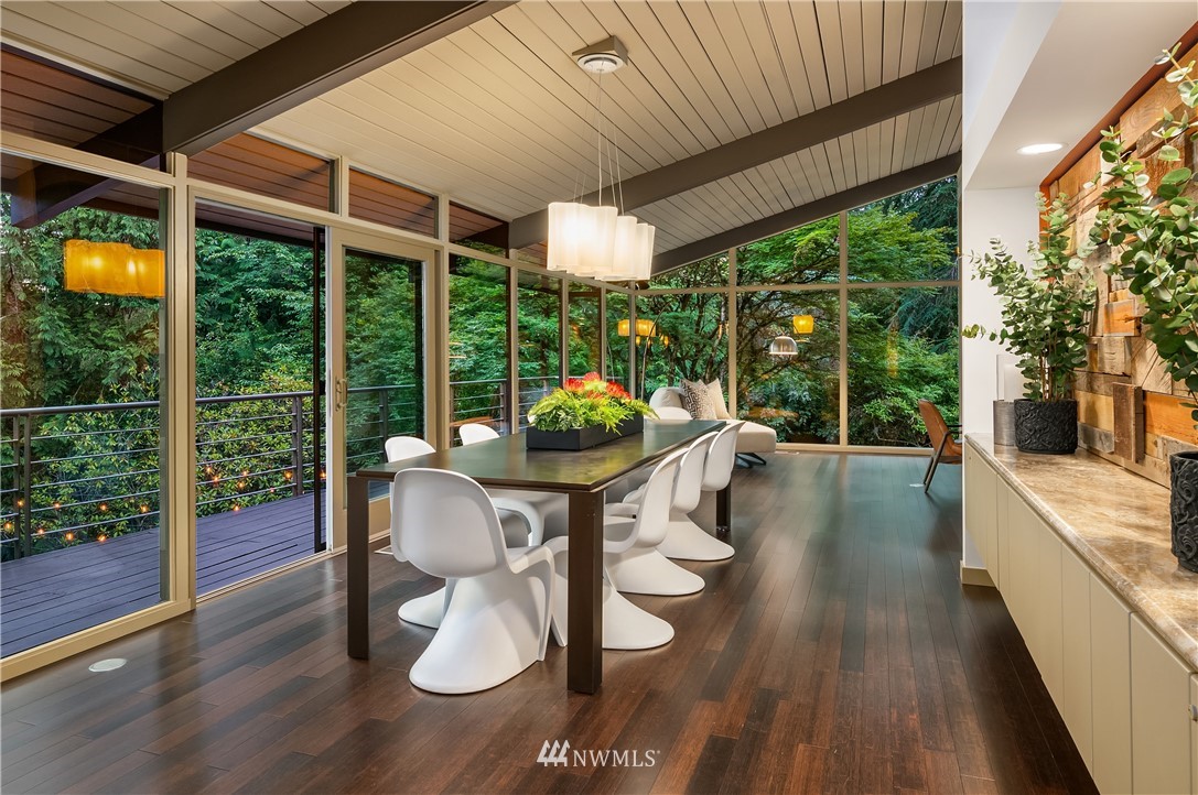 110 Northside Road Bellevue, WA 98004 - Photo 12 of 37 a porch with a table and chairs and potted plants