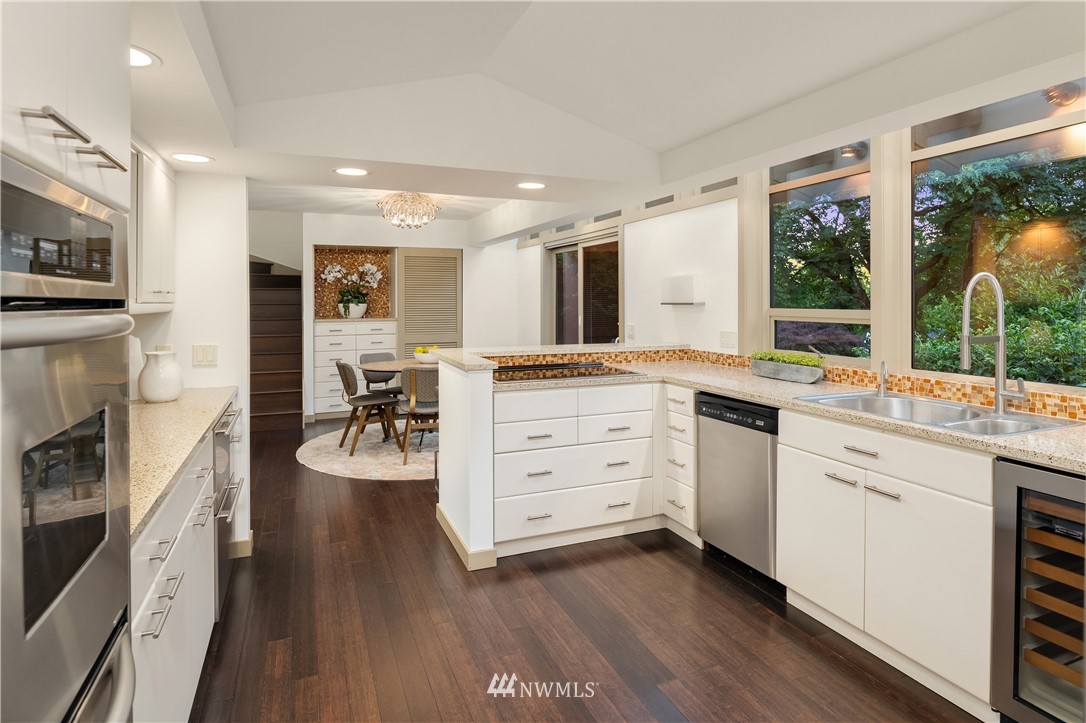 110 Northside Road Bellevue, WA 98004 - Photo 15 of 37 a kitchen with stainless steel appliances kitchen island granite countertop a stove and a sink