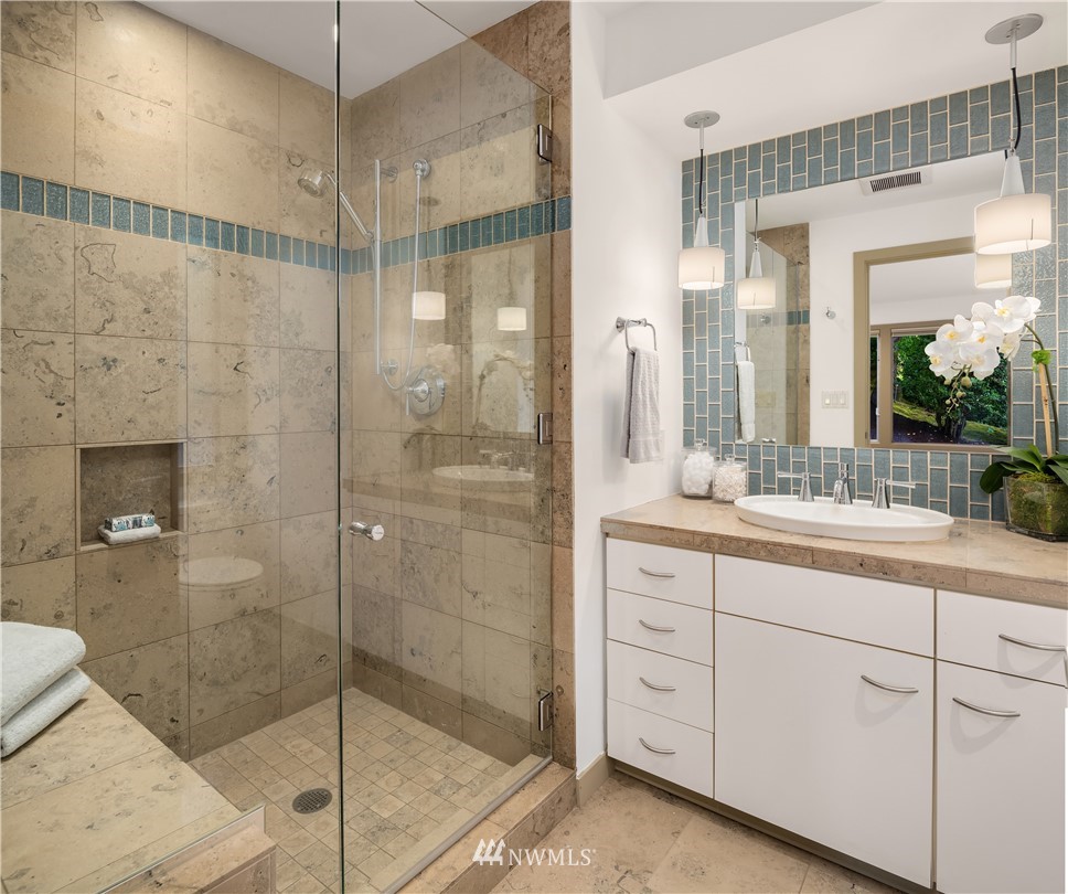 110 Northside Road Bellevue, WA 98004 - Photo 20 of 37 a bathroom with a shower sink and mirror