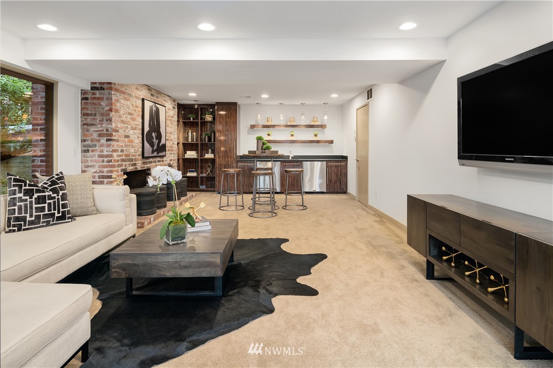 110 Northside Road Bellevue, WA 98004 - Photo 26 of 37 a living room with fireplace furniture and a flat screen tv