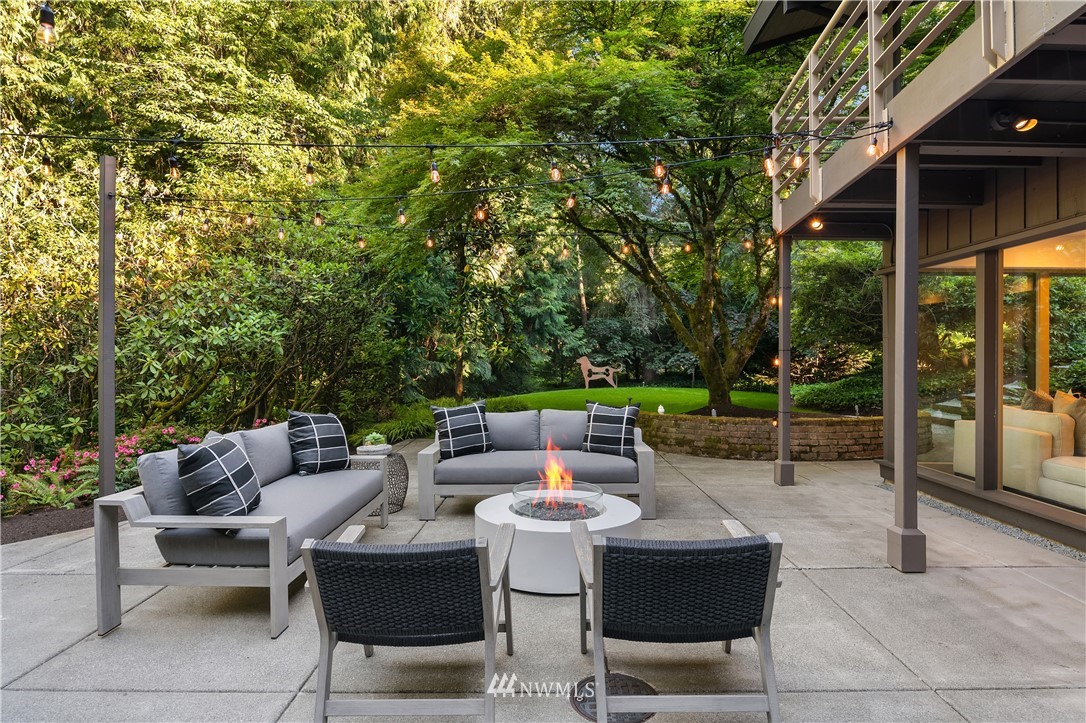 110 Northside Road Bellevue, WA 98004 - Photo 30 of 37 a view of a patio with a dining table and chairs with wooden floor