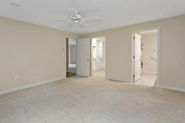 a view of an empty room with a ceiling fan