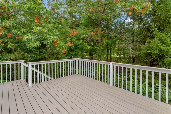 a balcony with wooden floor and fence
