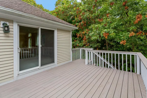 a view of backyard with deck and wooden floor