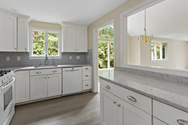 a kitchen with a sink window and cabinets