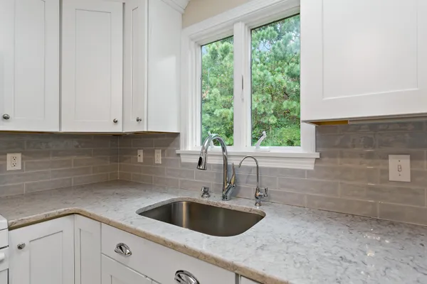 a kitchen with a sink and cabinets