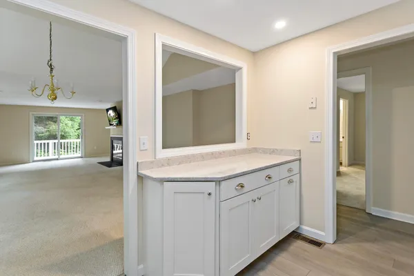 a bathroom with a granite countertop sink and a mirror
