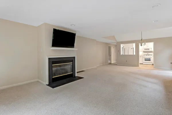 a view of a livingroom with a fireplace and a flat screen tv