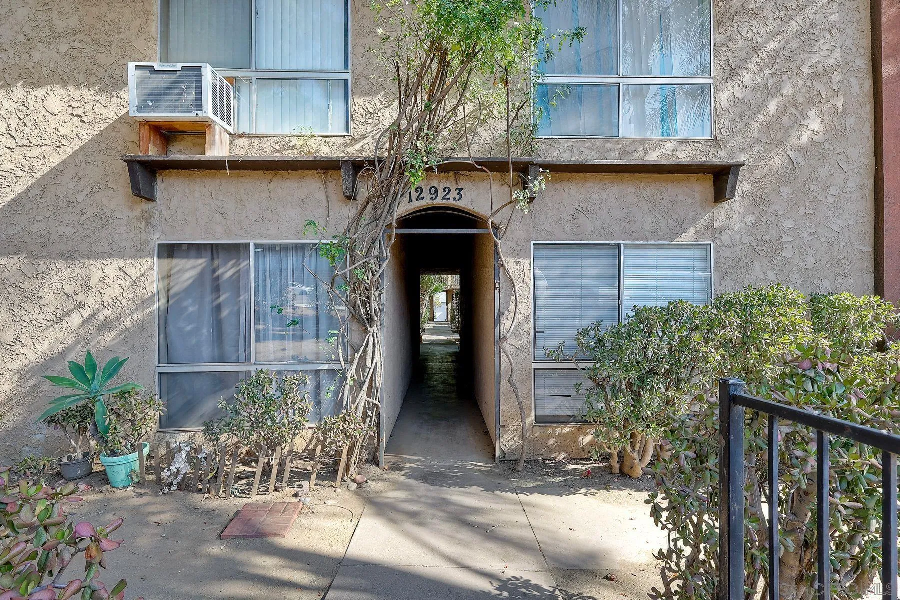 12923 Mapleview Street, Unit 6 Lakeside, CA 92040 - Photo 23 of 25 a front view of a house with garden