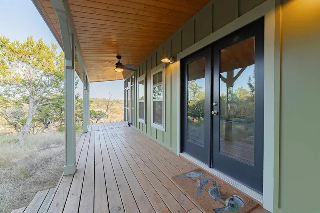 a view of a porch with wooden floor and outdoor space