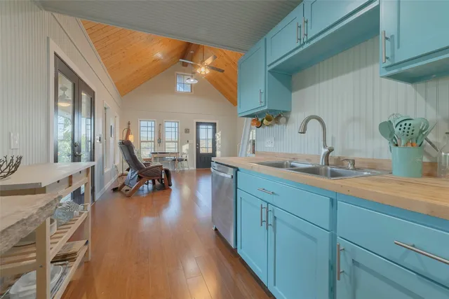 a kitchen with cabinets a sink and appliances