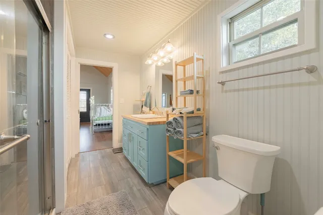 a bathroom with a sink and mirror with toilet