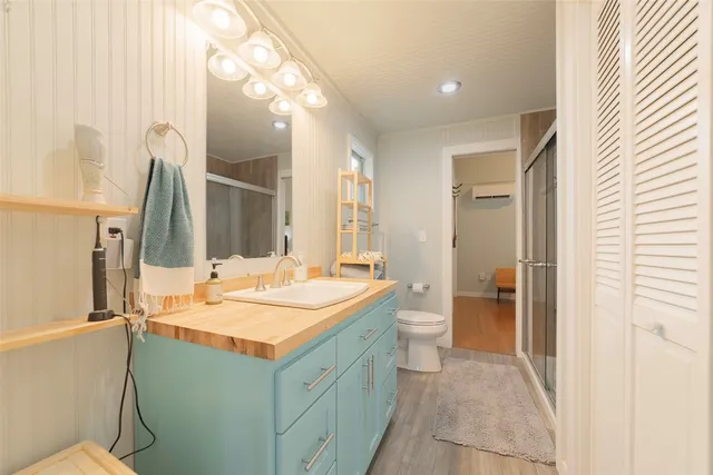 a view of a workspace with furniture and wooden floor