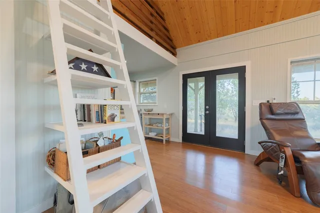 a view of a room with wooden floor