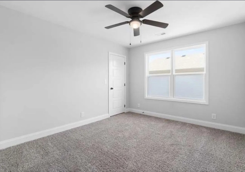 64 West High Street Clarksville, TN 37040 - Photo 11 of 18 an empty room with a empty space and a ceiling fan