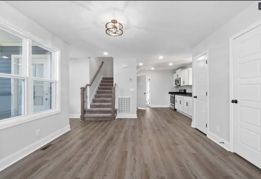 64 West High Street Clarksville, TN 37040 - Photo 2 of 18 a view of a room with wooden floors and stairs