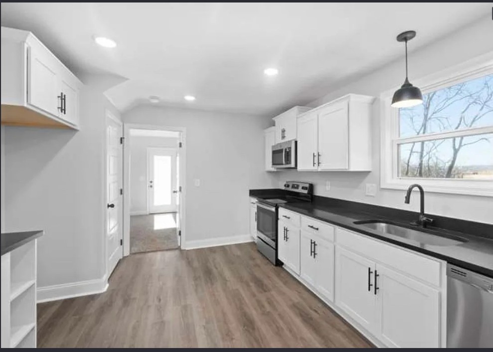 64 West High Street Clarksville, TN 37040 - Photo 3 of 18 a kitchen with granite countertop white cabinets and white appliances