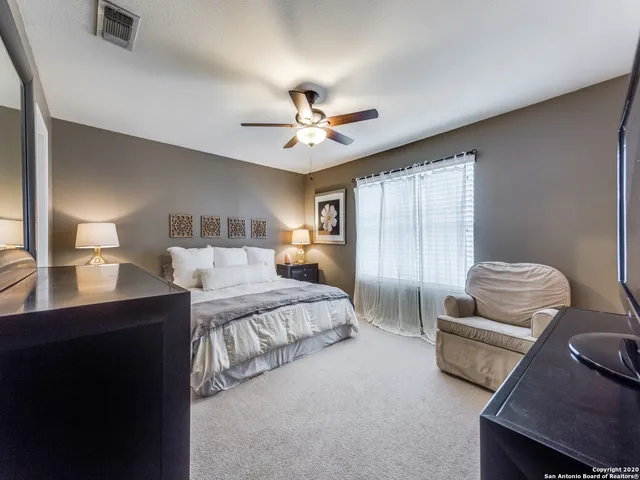 a spacious bedroom with a bed and furniture