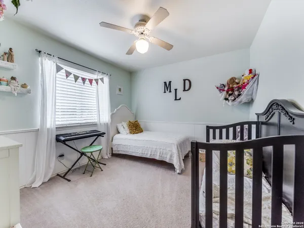 a bedroom with furniture window and a ceiling fan