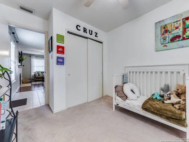 a bedroom with furniture and a book shelf