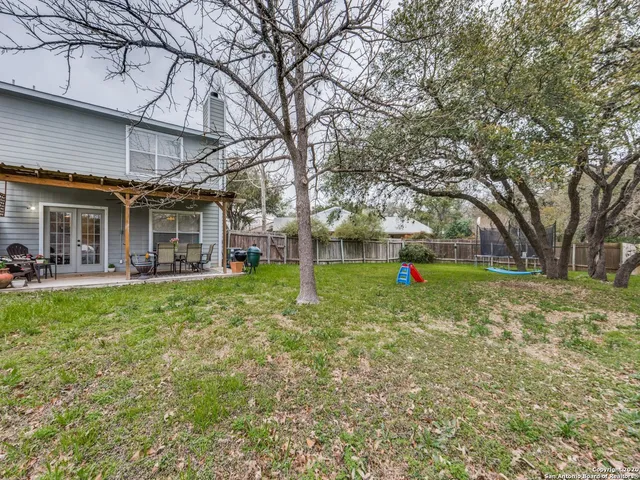 a view of a house with backyard and sitting area