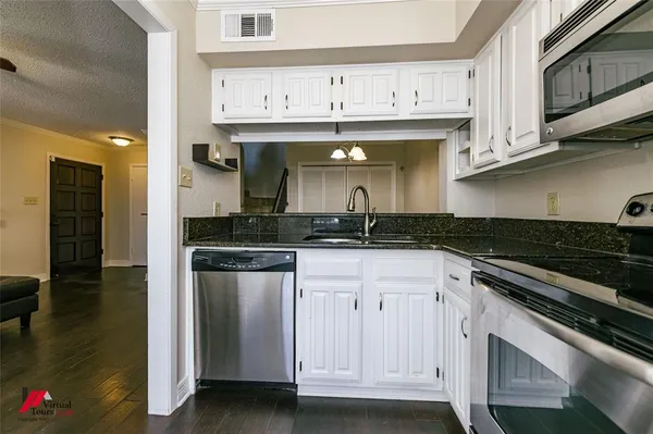a kitchen with stainless steel appliances granite countertop a sink and cabinets
