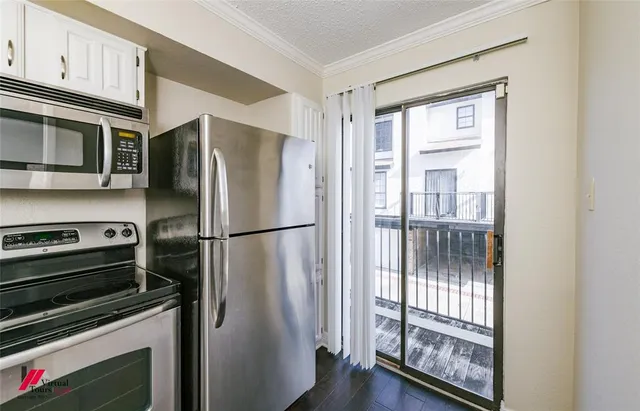 a metallic refrigerator freezer sitting in a kitchen