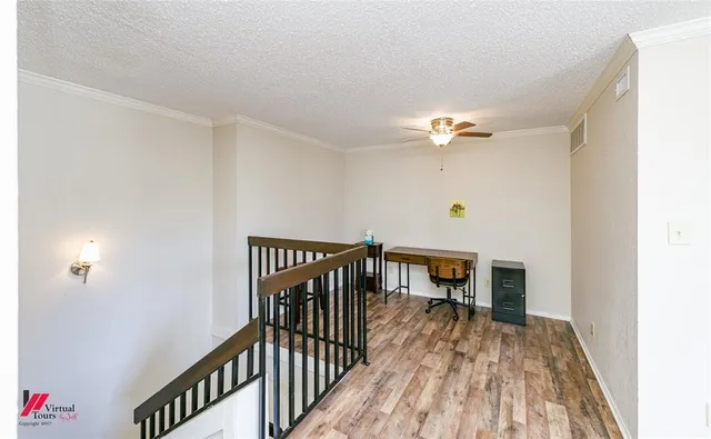 a view of a hallway with wooden floor and a chandelier