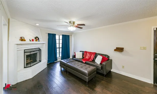 a living room with furniture fireplace and wooden floor