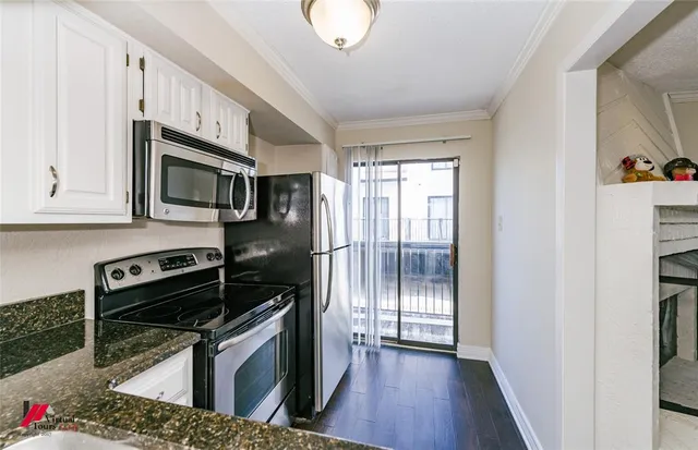 a kitchen with granite countertop a stove and a refrigerator