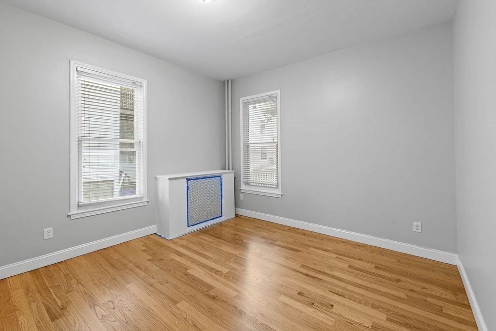 18 Holborn Street Boston, MA 02121 - Photo 15 of 33 a view of empty room with wooden floor and fan