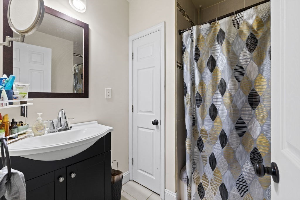 18 Holborn Street Boston, MA 02121 - Photo 18 of 33 a bathroom with a sink and a mirror