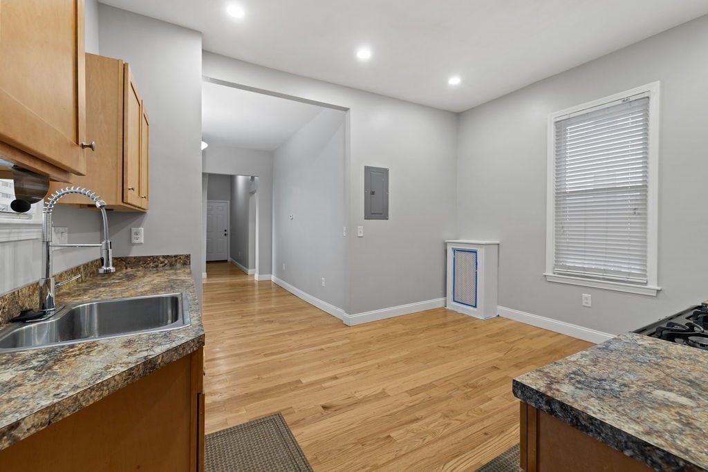 18 Holborn Street Boston, MA 02121 - Photo 6 of 33 a kitchen with granite countertop a sink and a stove
