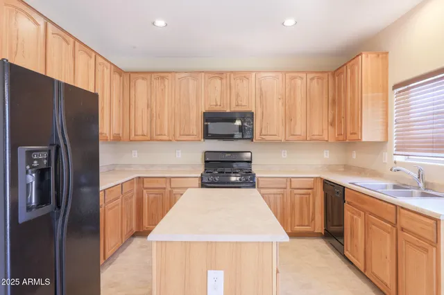 a view of a kitchen with a sink and dishwasher a kitchen island with wooden floor