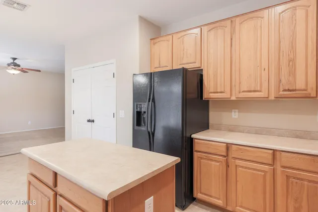 a kitchen with granite countertop a refrigerator stove top oven and sink
