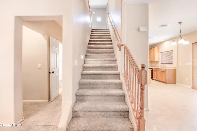 a kitchen with granite countertop a refrigerator stove and microwave
