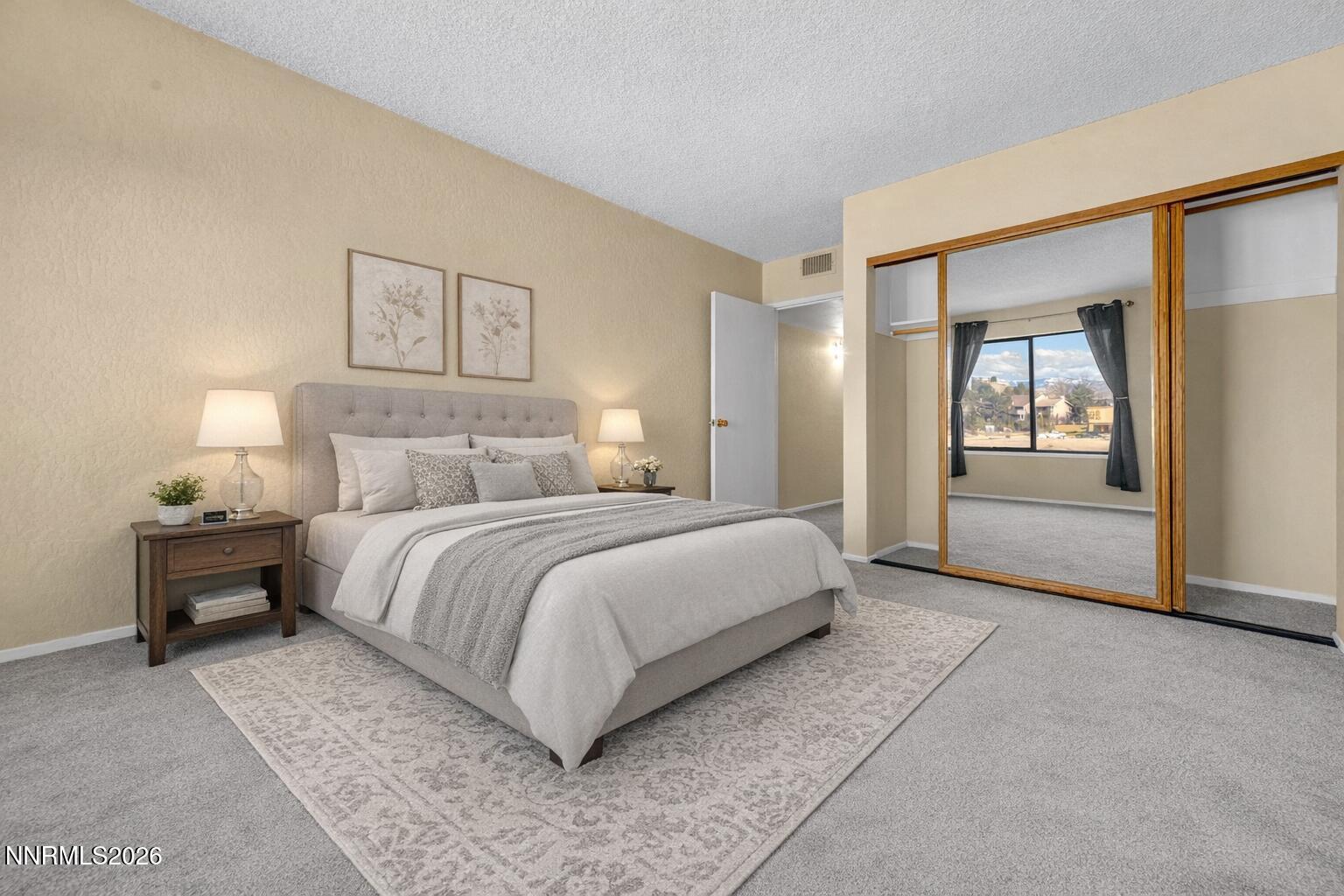 2845 Idlewild Drive, Unit 204 Reno, NV 89509 - Photo 11 of 29 a bedroom with a large bed and a painting on the wall