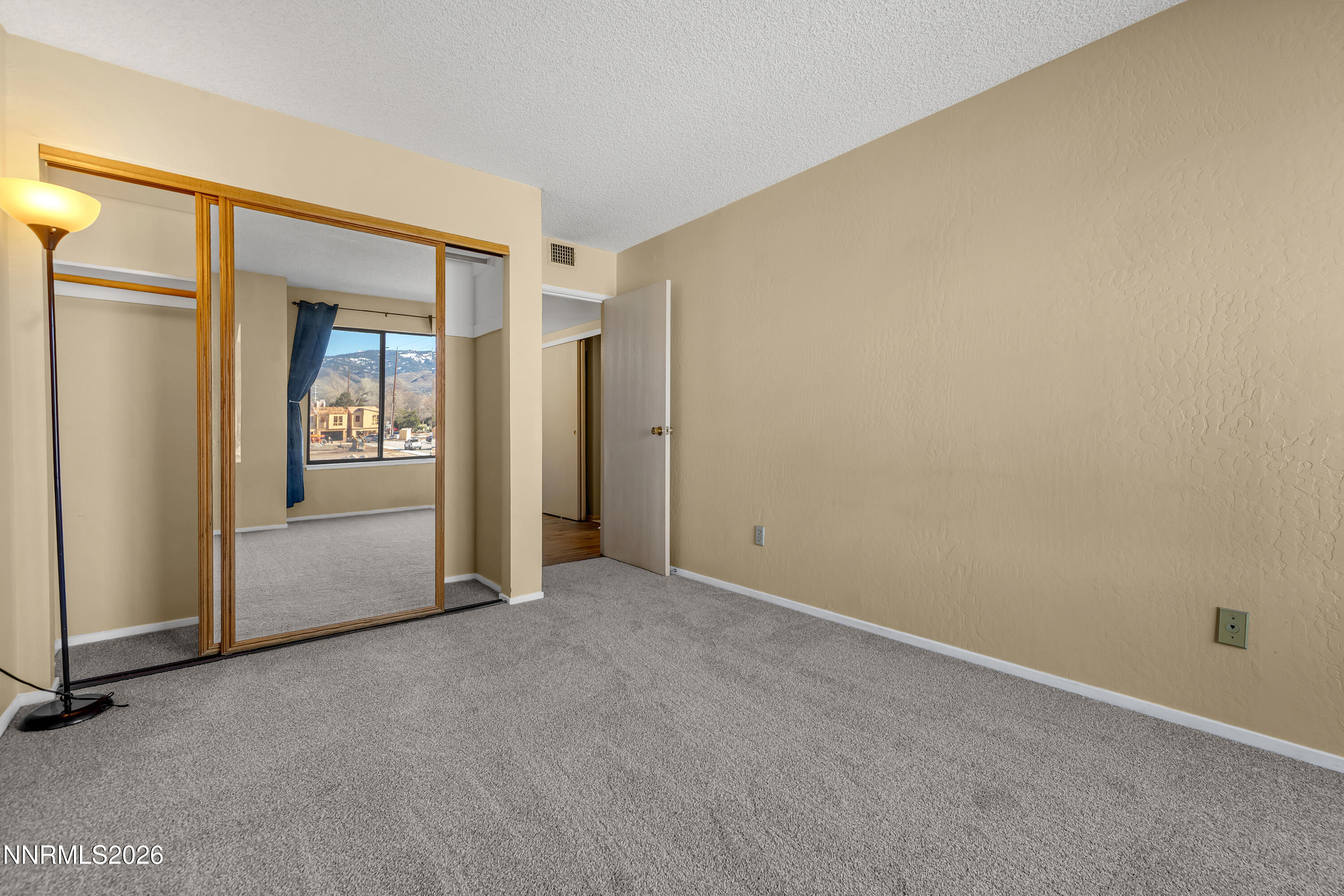 2845 Idlewild Drive, Unit 204 Reno, NV 89509 - Photo 17 of 29 an empty room with windows and closet