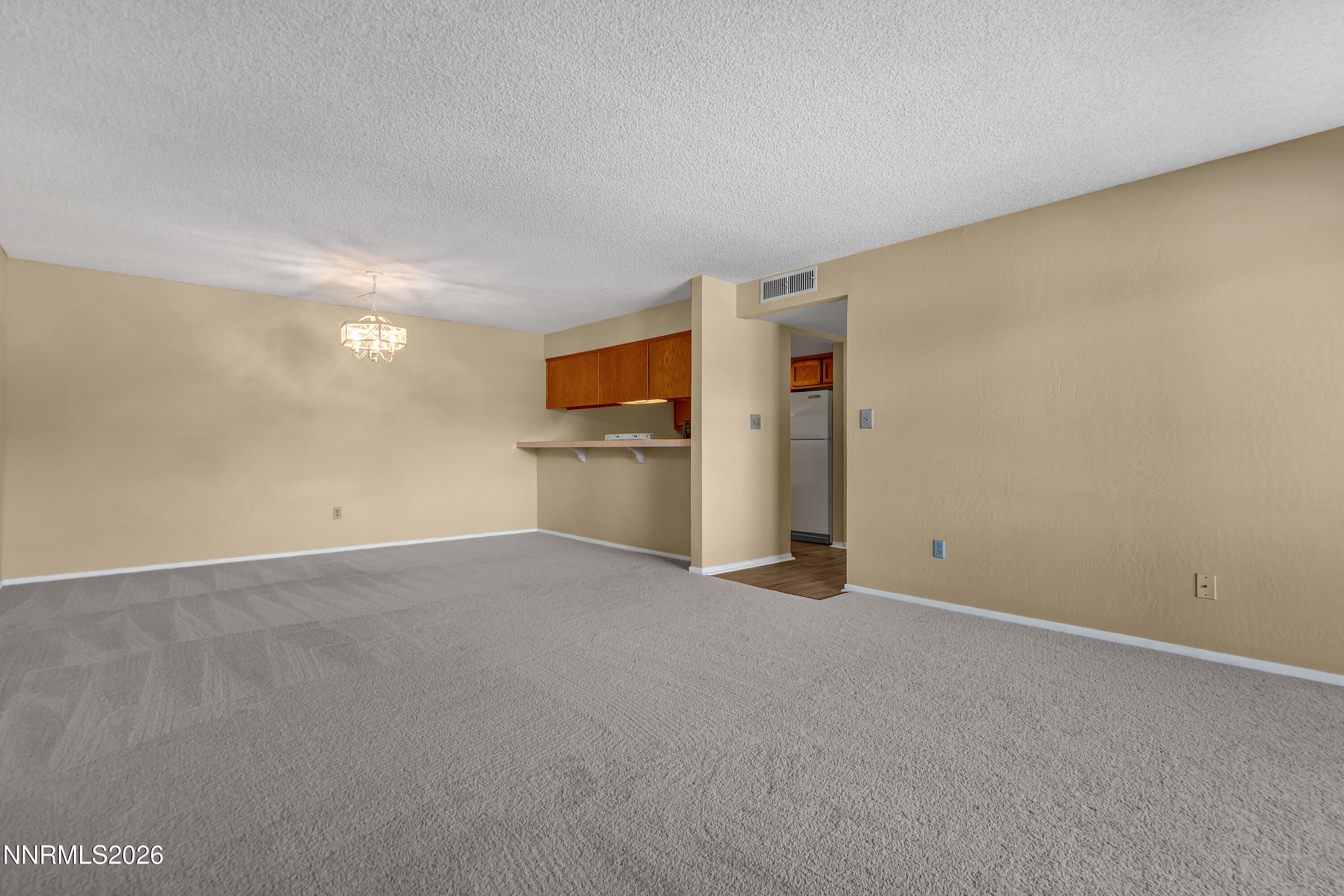 2845 Idlewild Drive, Unit 204 Reno, NV 89509 - Photo 4 of 29 a view of empty room with furniture and refrigerator