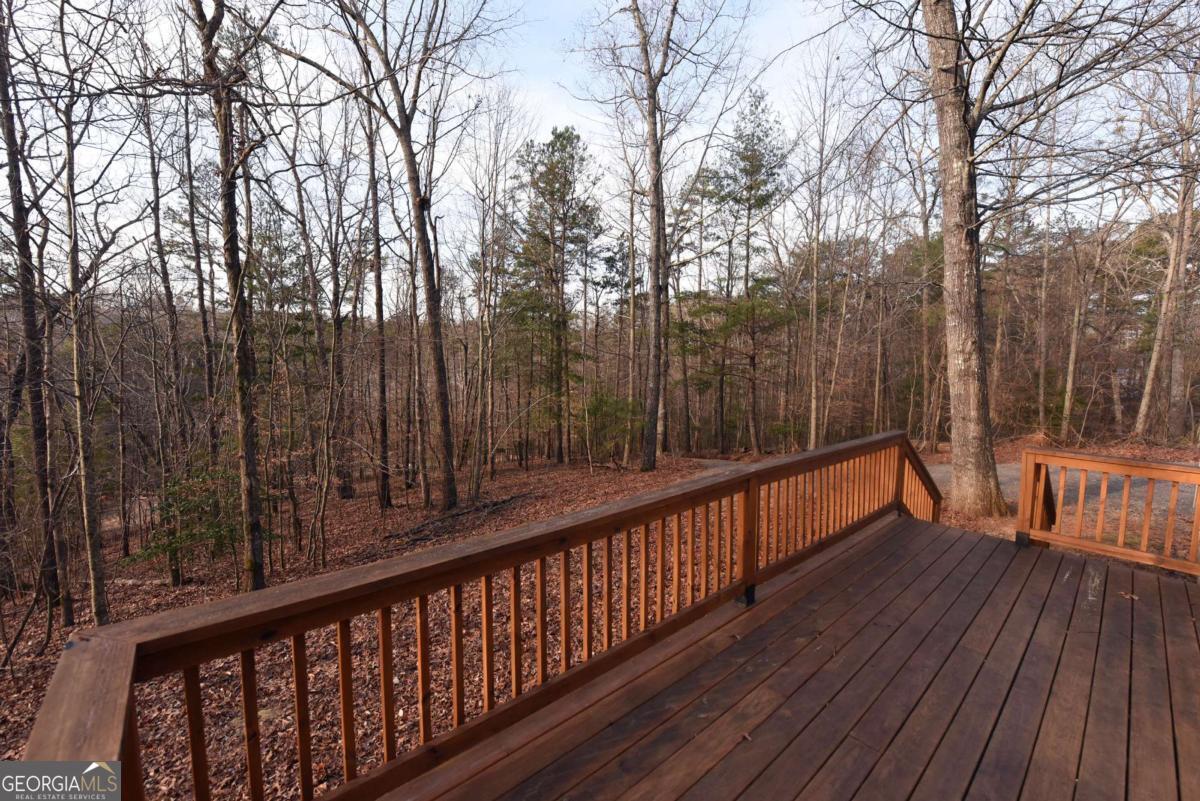 273 Rose Ray Road Ellijay, GA 30540 - Photo 12 of 32 a balcony with wooden floor and trees