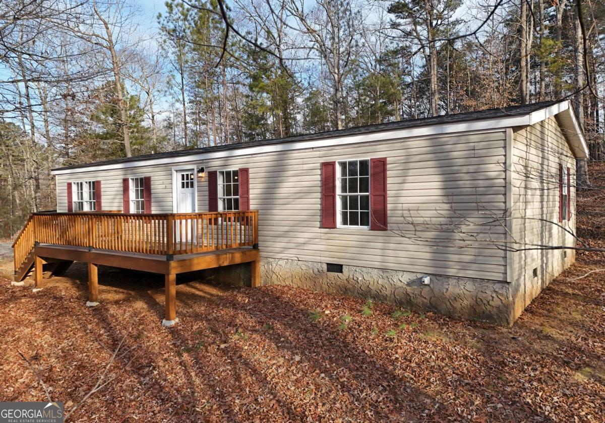 273 Rose Ray Road Ellijay, GA 30540 - Photo 13 of 32 a backyard of a house with wooden deck and outdoor seating