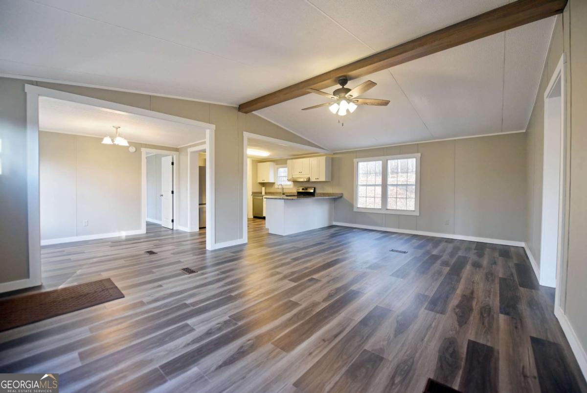 273 Rose Ray Road Ellijay, GA 30540 - Photo 17 of 32 wooden floor in an empty room with a window