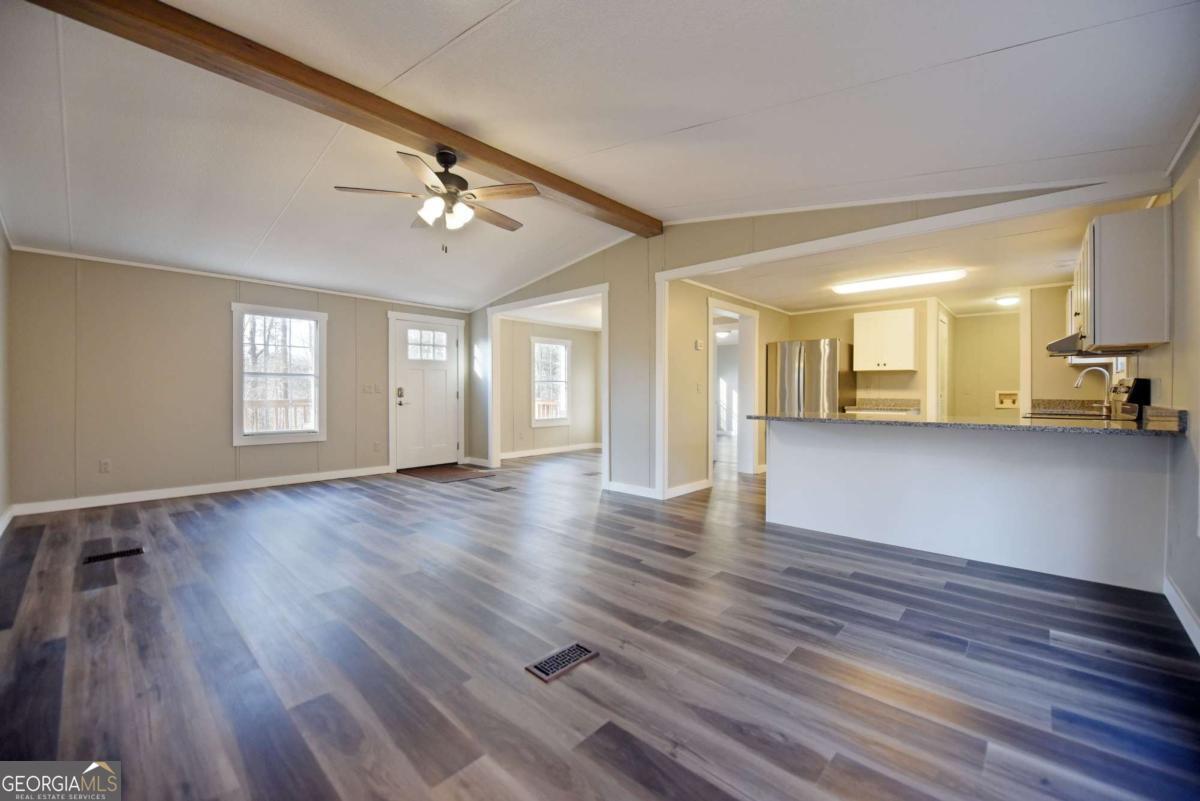 273 Rose Ray Road Ellijay, GA 30540 - Photo 18 of 32 a view of an empty room with a window and wooden floor