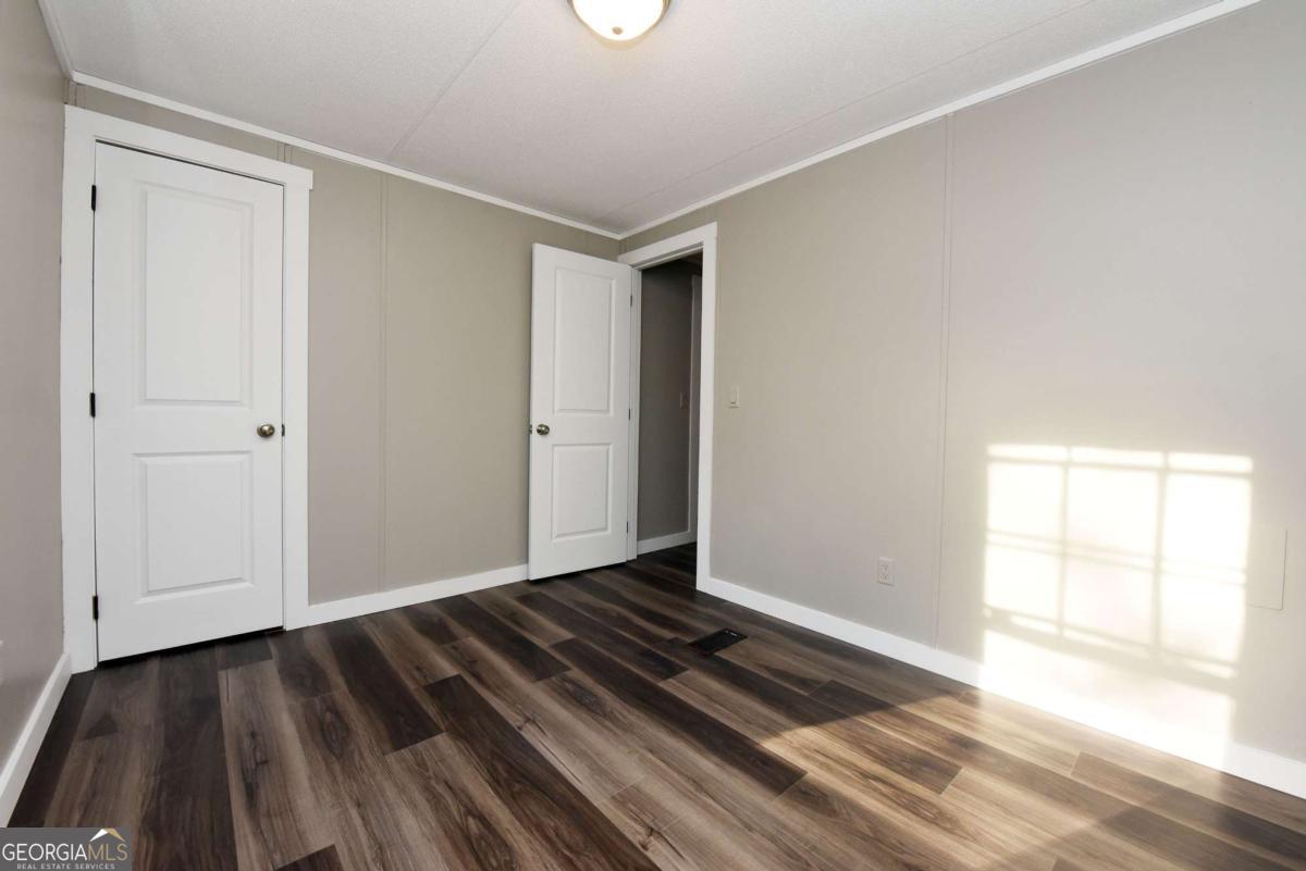 273 Rose Ray Road Ellijay, GA 30540 - Photo 24 of 32 a view of an empty room and wooden floor