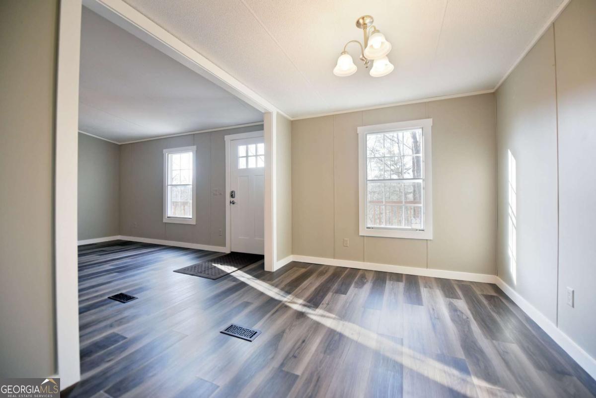 273 Rose Ray Road Ellijay, GA 30540 - Photo 26 of 32 an empty room with wooden floor and windows