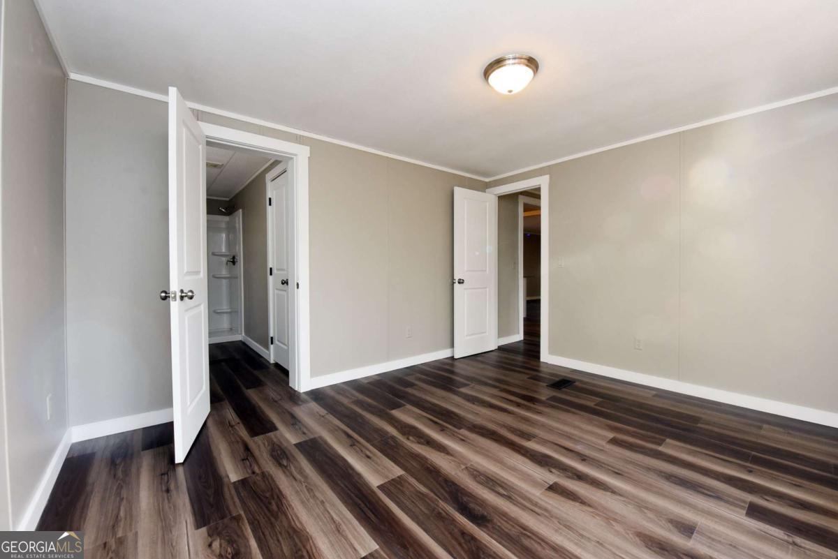 273 Rose Ray Road Ellijay, GA 30540 - Photo 29 of 32 a view of an empty room with wooden floor