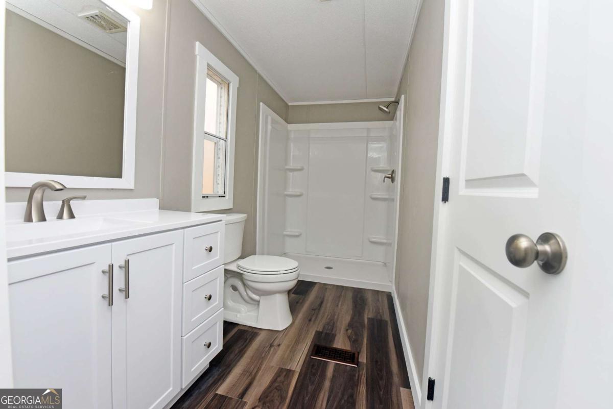 273 Rose Ray Road Ellijay, GA 30540 - Photo 30 of 32 a bathroom with a sink and a mirror